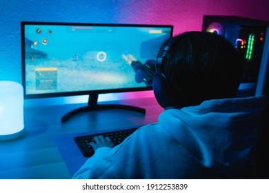 Girl Playing Shooter Online Video Game - Technology Trend Concept - Main Focus On Headphones