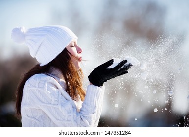 Girl Playing With Snow In Park