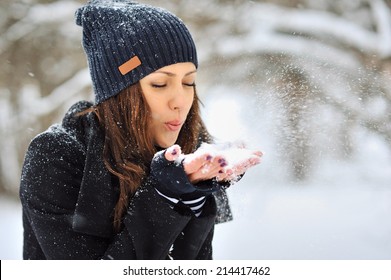 Girl Playing With Snow In Park