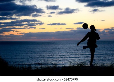 Girl Playing With Soccer Ball On Beach