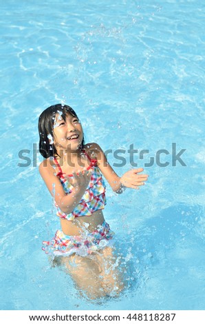 Girl playing in the swimming pool