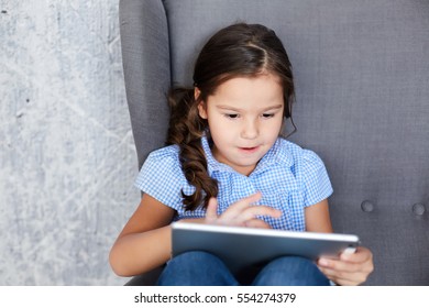 Girl Playing In The Tablet