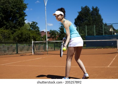 Girl playing tennis on the court - Shutterstock ID 205257892