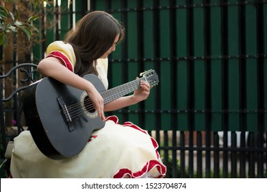 girl playing traditional chilean cueca on guitar	