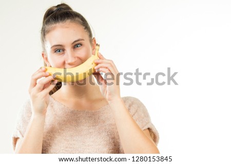 a girl plays with a banana and had fun