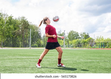 Girl Plays Football On Grass