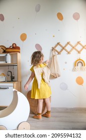 girl plays in the playroom, cozy and beautiful interior of the nursery, Scandinavian interior of the playroom - Shutterstock ID 2095594132
