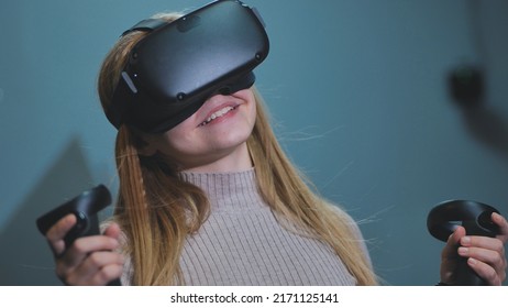 The girl plays virtual reality games in the club.