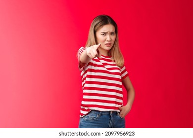 Girl plead you guilty. Upset asian blond girlfriend being cheated on pointing camera blame person make accusations, frowning disappointed and hurt, stand red background bothered offended