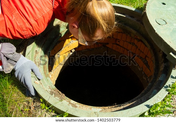 Girl Plumber Looks Into Open Draining Stock Photo (Edit Now) 1402503779