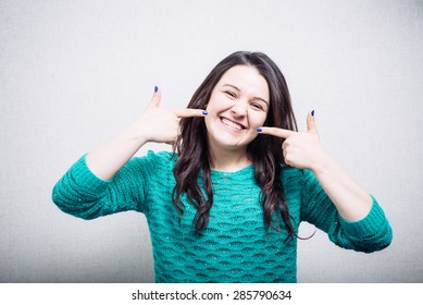 Girl Pointing Finger At His Teeth With Braces