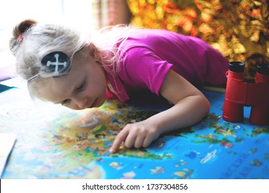 The Girl Points A Finger At Something On The Map. Pirate Game, Orienteering, Family Home Games, Travel And Adventure Planning