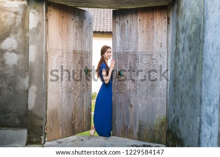 Similar – Woman in front of a yellow beach house