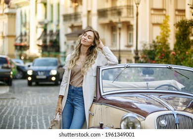 girl posing next to the car