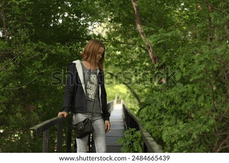 Similar – Beautiful young woman smiling and walking happy on the park outdoors