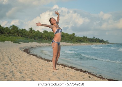 A girl posing on the shore, Xcacel beach, Playa del Carmen, Mexico