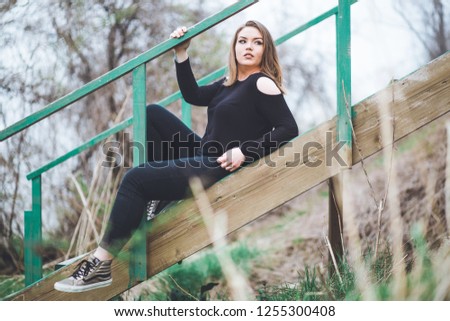 Similar – young girl standing near old building with wires