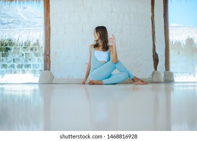 Girl practice yoga in blue clothes.