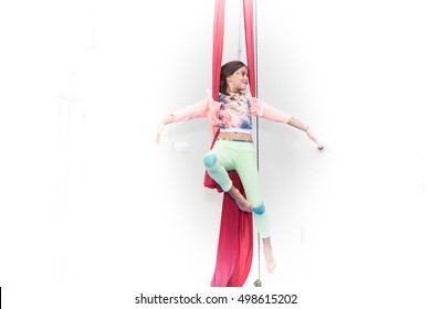 Girl Practices Circus Class On Red Silk