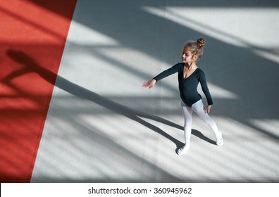 Girl practicing rhythmic gymnastics in the gym - Powered by Shutterstock