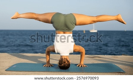Similar – Image, Stock Photo Flexible woman performing headstand pose in yoga studio