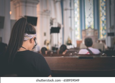 A Girl Is Praying In The Church.