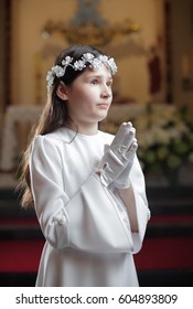 Girl praying in the church / First holy communion