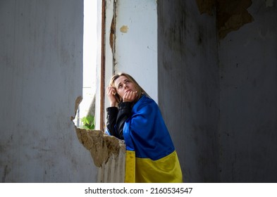 Girl Praying For An End To The War. Ukrainian Woman In A Destroyed House. A Woman Prays For Peace. Peace Concept. Consequences Of The War In Ukraine. Destroyed Ukrainian Houses. War In Ukraine.