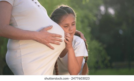 girl pregnant woman. daughter hugging her pregnant mother's belly. girl pregnant woman happy family kid dream concept. the girl loves her unborn brother, mother equally lifestyle loves two children - Powered by Shutterstock