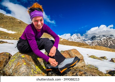 Girl preparing her hiking boots