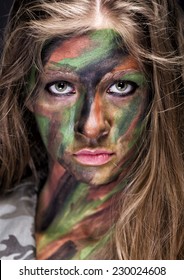 Girl In Protective Camouflage With Military Makeup On Her Face