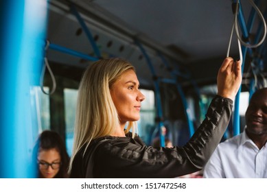 A girl in public transport is holding on to a handle - Powered by Shutterstock