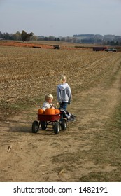 Girl Pulling Boy In A Wagon