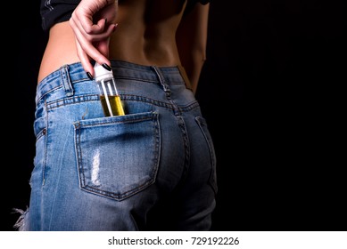 girl pulls a bottle of vape liquid out of her back pocket