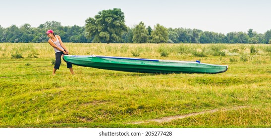 Girl pulls on the field kayak - Powered by Shutterstock