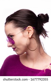 girl in a purple sweater, purple glasses with purple lipstick on her lips - Shutterstock ID 1677792355