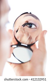 Girl  Put Make Up On Eye Close Up Reflection In Mirror Isolated On White