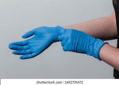 girl puts on protective gloves during the coronavirus epidemic. the use of protective gloves in an epidemic. Kovid-19 coronavirus protection