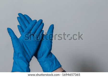 girl puts on protective gloves during the coronavirus epidemic. the use of protective gloves in an epidemic. covid-19 coronavirus protection