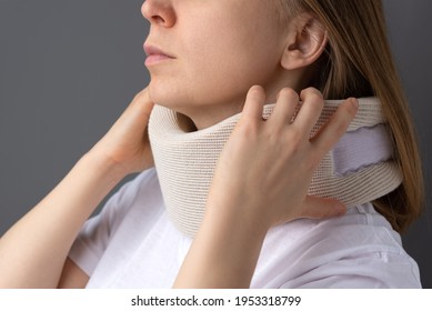 The Girl Puts On A Supportive Collar For The Neck. Medical Corset For Fixing The Neck.