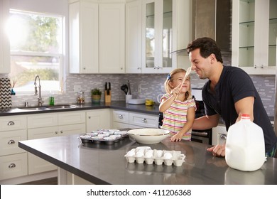 Girl Putting Cake Mix On DadÃ¢??s Nose While They Bake Together