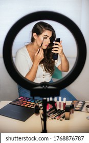 Girl Putting Makeup On Herself With A Ring Of Light