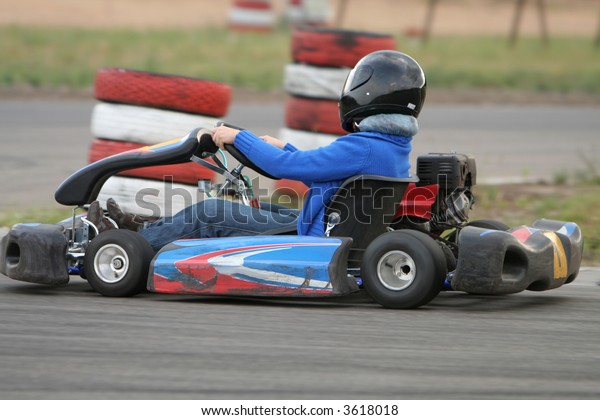 Girl in racing kart with\
number one