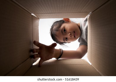 Girl Reaching For Something Inside The Box