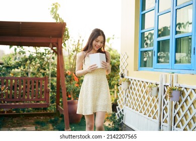 The girl is reading in the yard - Shutterstock ID 2142207565