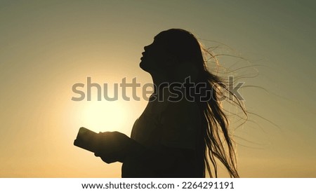 girl reads bible book sunset. bible hand. sun book. pray sunset reading bible. man girl ask forgiveness from sun. religious man reads book rays sunlight. travel millennium with book. prayer read.