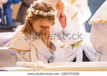 girl reads a prayer for the first communion. First Communion