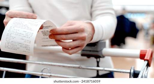 a girl with a receipt from shopping at the supermarket. High quality photo - Powered by Shutterstock