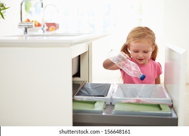 Girl Recycling Kitchen Waste In Bin