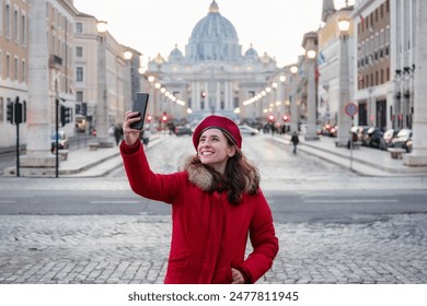 Girl in red dress and red beret takes a selfie with the background of St. Peter's Basilica in the Vatican.  - Powered by Shutterstock